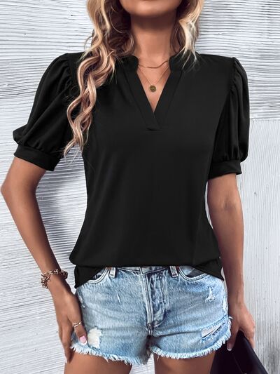 Blusa con mangas abullonadas y muescas