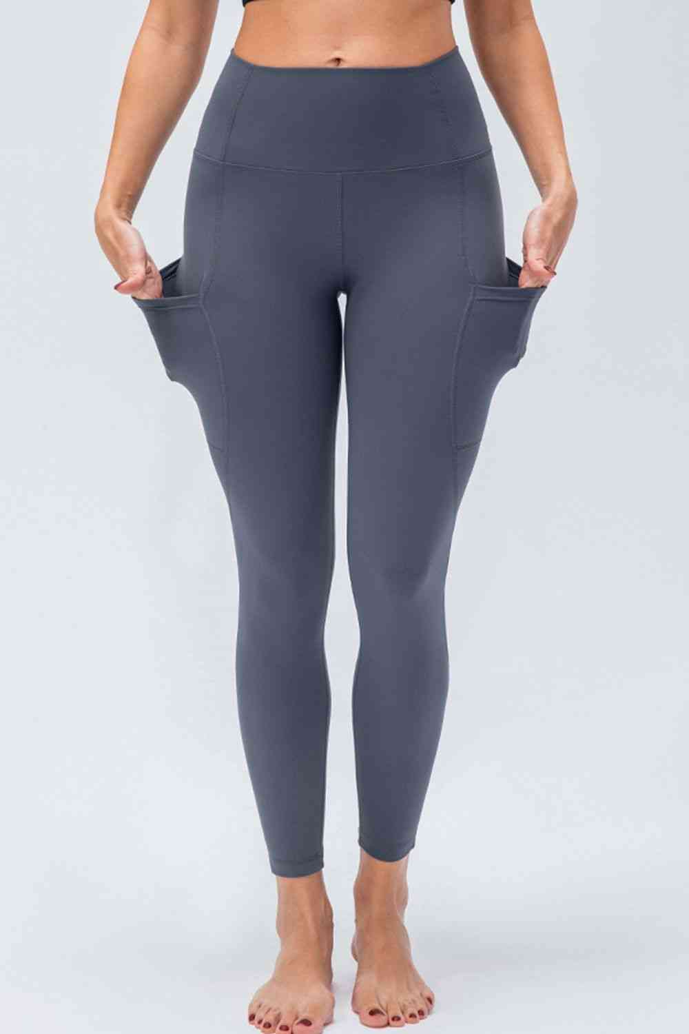 Leggings activos transpirables con cintura ancha y bolsillos